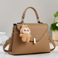 Brown litchi leather handbag with gold metal clasp and plush rabbit pendant charm - Khaki