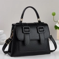 Minimalist black lychee leather handbag with golden hardware and adjustable crossbody strap - Black