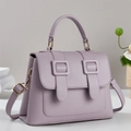 Minimalist lavender pebbled leather satchel handbag shown from a front-side angle - Purple