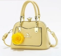 Detail of yellow faux leather handbag with golden cat logo and large floral ornament - Light Yellow