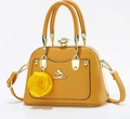 Detail of yellow tote bag with golden cat logo and decorative 3D rose charm attachment - Orange