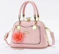 Pink crossbody handbag detail with golden cat logo and large rose charm pendant - Pink