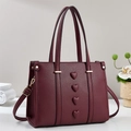 Deep burgundy leather bucket bag with 3D heart charms and adjustable gold-tone strap - Red
