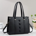 Fashionable black pebbled leather tote bag with heart embossed design and gold hardware - Black