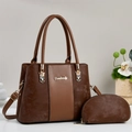 Detail of dark brown tote bag set with pebble grain leather and golden hardware - Brown