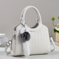 Elegant white bucket bag with crocodile texture, silver hardware and a plush charm - White
