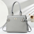 Dunkelgraue Handtasche mit Metalldrehverschluss und Doppelgriffen auf modernem Hintergrund - L33 H25 B13 / Grau