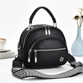 Black pebbled leather shell bag with multi-layer zippers and wide woven strap - Black