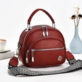 Minimalist shell satchel in deep red pebble leather with geometric woven strap - Wine Red