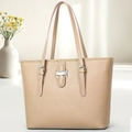 Detail of lychee pattern leather tote bag with silver buckle on a minimalist desk - Khaki