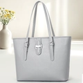 Detail of grey lychee textured leather tote bag with silver metal buckle and reinforced straps - Gray