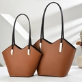 Brown leather tote bag set with V-shaped opening and black handles in soft window light - Large and Small 2-Piece Set / Earthy Yellow