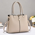 Detail of lychee pattern leather tote bag with elegant handles and beige texture - Light Khaki