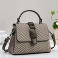 Close-up of olive green leather trim and herringbone fabric detail on women's handbag - Green