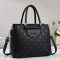 Detail of black pebbled PU leather tote with geometric diamond quilting and gold hardware - Black