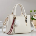 Chic beige lychee textured handbag with gold hardware and plush charm pendant - Off-white