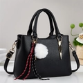 Black pebble leather handbag for women with plush charm and adjustable shoulder strap - Black