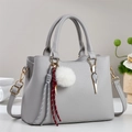 Elegant grey PU leather handbag with white fur ball charm and dual top handles - Gray