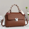 Detail of dark brown tote bag with crocodile embossing, silver lock, and silk scarf - Khaki/Earth Yellow