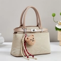 Chic beige textured crossbody bag with silver clasp and plush bear charm decoration - Khaki