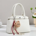 White lychee pattern leather handbag with silver twist lock and plush bear charm - Off-white