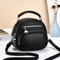 Minimalist black pebbled leather mini crossbody bag with silver hardware and multi-zipper layers - Black