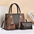 Detailed view of tote bag and envelope pouch set with cherry print and gold hardware - Coffee