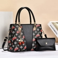Detail of black cherry print handbag with gold hardware and matching coin purse - Black