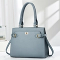 Detail of grey-blue leather handbag with golden metal twist lock and textured finish - Blue