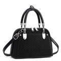 Detail of woven texture and smooth leather panels on black tote bag with silver zippers - Black