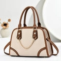 Detail of elegant two-tone handbag with golden chain and pebble leather texture - Off-white
