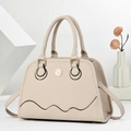 Detail of beige pebble leather handbag showing gold logo and shell-shaped design - Off White