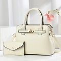 Cream white leather tote bag set with gold hardware and small wallet on minimalist display - White