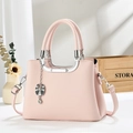 Elegant pink lychee leather handbag with silver hardware and adjustable shoulder strap - Pink
