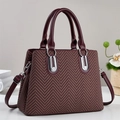 Elegant chevron pattern handbag with burgundy leather trim and dual handles shown from side view - Red