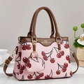 Pink tote bag with cherry print, brown leather handles and a matching small coin purse - Pink