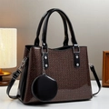 Detail of brown sequin tote bag with black patent leather handles and round charm - Coffee