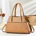 Detail of crocodile embossed leather tote bag with golden hardware and stylish handle - Brown