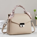 Detail of beige lychee grain leather bag with decorative geometric silk scarf handle - Khaki
