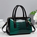 Green crocodile embossed Boston handbag with glossy black leather panels and gold hardware - Green