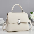 Detail of beige litchi grain texture bag with silver metal lock and top handle - Off-white