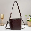 Detail of dark brown bucket bag featuring vintage leather texture and chain strap - Coffee