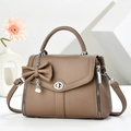Brown litchi grain leather crossbody bag with pearl bow charm and silver swivel lock - Khaki
