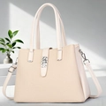Detail of beige tote bag featuring textured fabric with leather trim and silver metal buckle - Apricot