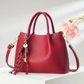 Elegant red litchi leather handbag with double handles and golden hardware on pedestal - Wine Red