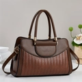 Brown contrast stitch leather top handle crossbody bag on a minimalist stone base - Earthy Yellow
