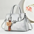 Silver grey metallic shoulder bag with bow buckle, plush bear charm and floral accents - Silver