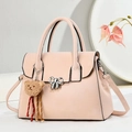 Pink shoulder bag detail with metal bow clasp and a cute brown teddy bear charm - Pink
