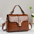 Detailed close-up of brown crocodile texture and gold metal buckle on leather handbag - Khaki/Earth Yellow