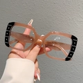 Macro detail of square glasses frame with silver stud accents and tea gradient finish - Black Edge Tea Frame